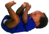Photographs of a baby laying on his back with his arms and feet in the air.